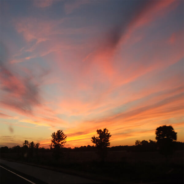 a beautiful sunset driving west along highway 401
