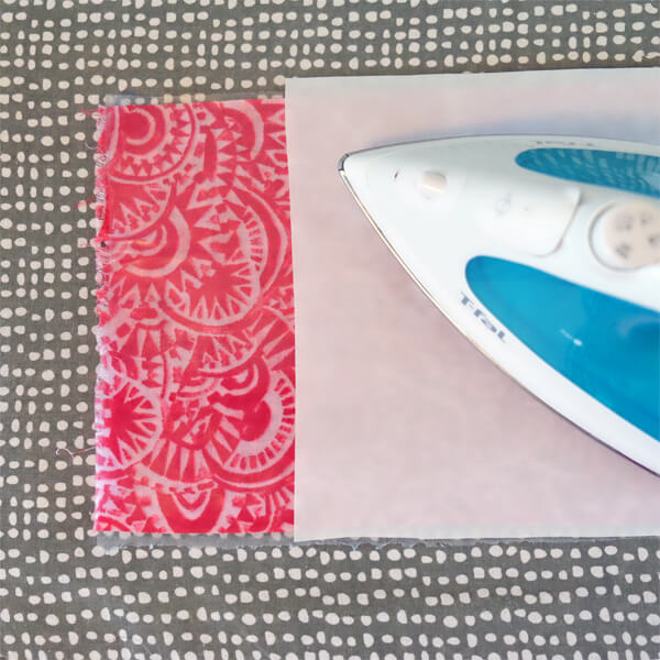 ironing the vinyl onto the cotton fabric