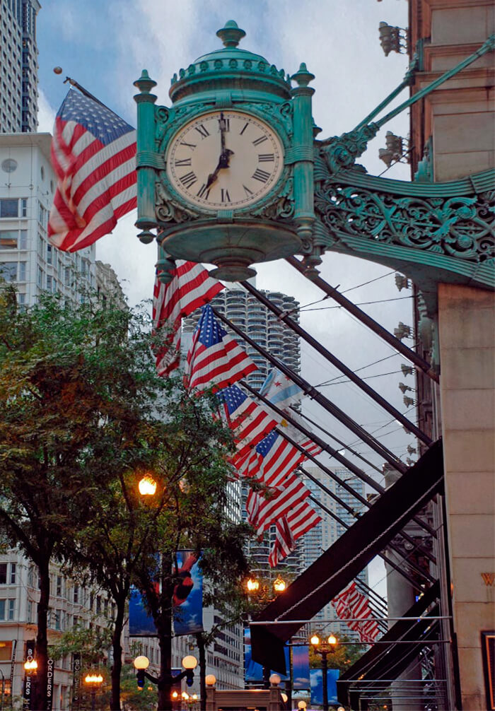 a clock and American flags outside Macy's in Chicago