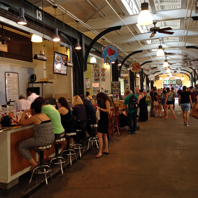 photo of customers at vendor's counter in French Quarter Market