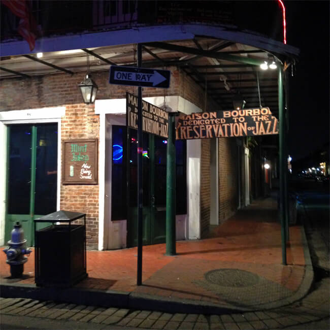 photo of the entrance to Maison Bourbon, New Orleans. Sign reads "Maison Bourbon Dedicated to the Preservation of Jazz"