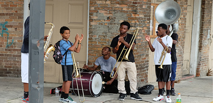 6 young men play jazz on a French Quarter street corner